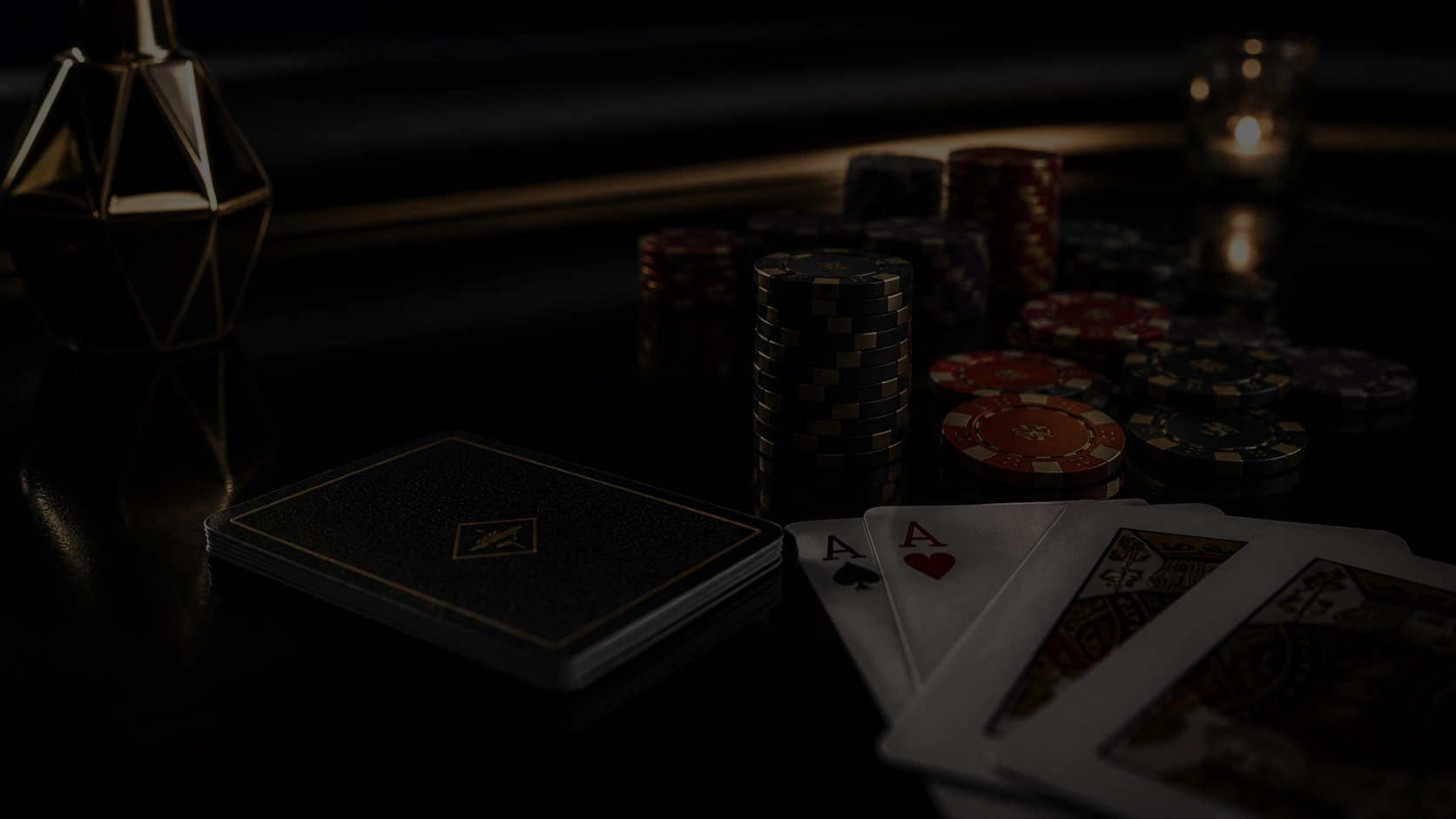 Dark casino table with stacked chips and four aces in cinematic low light poker atmosphere